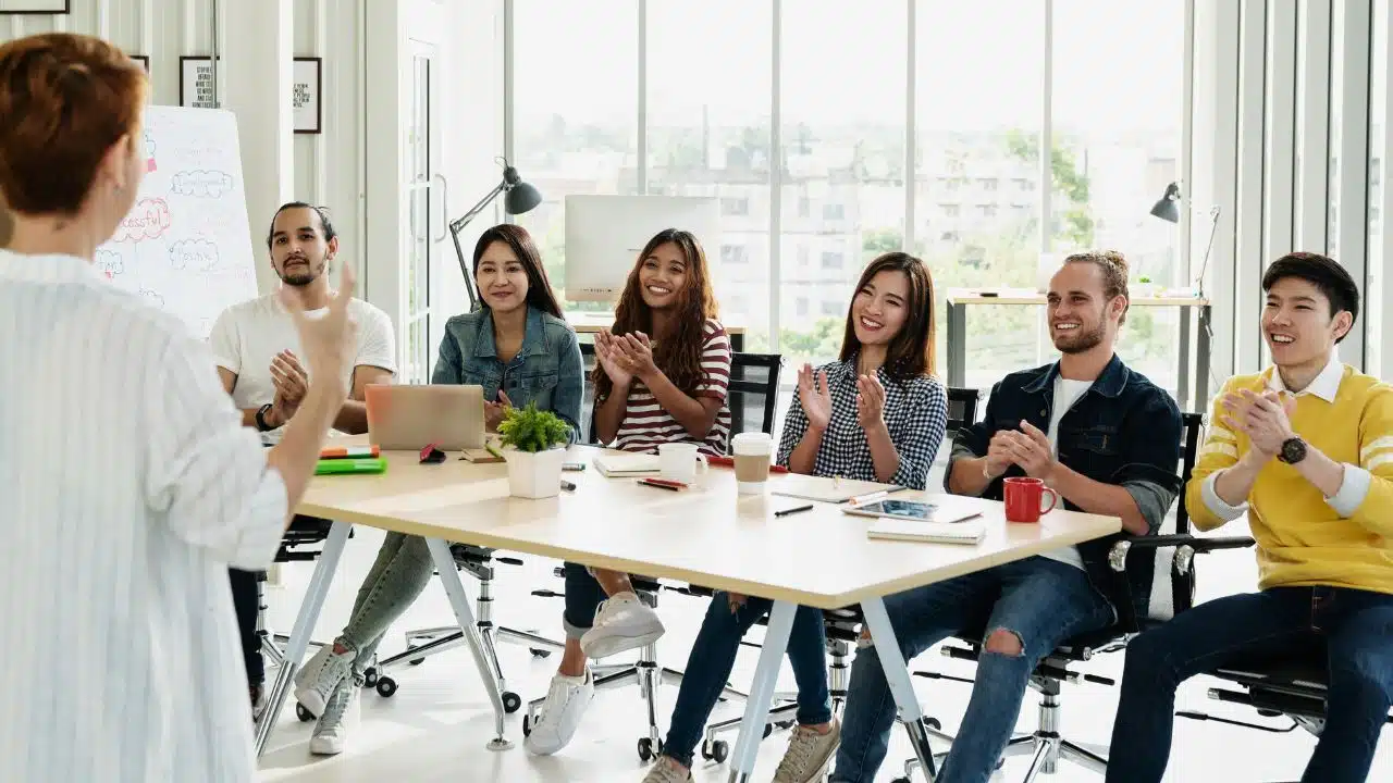 woman giving presentation at work to group