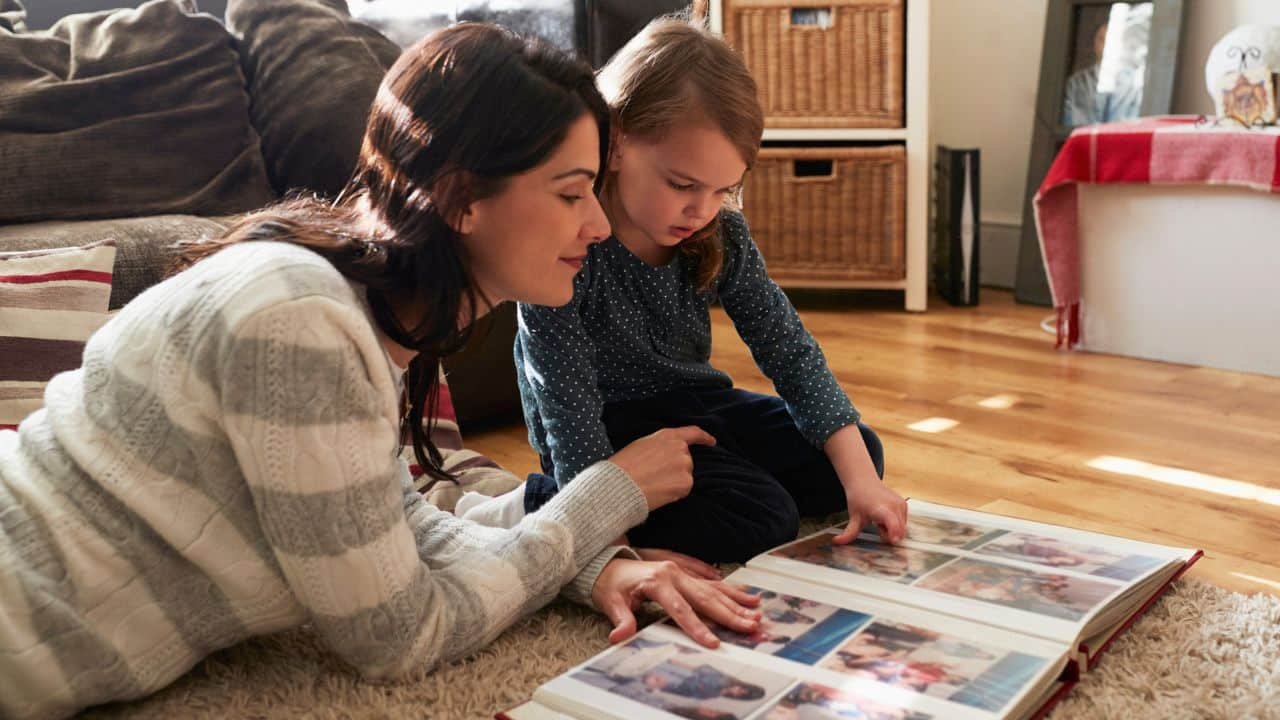 Mother And Daughter Looking Photo Album