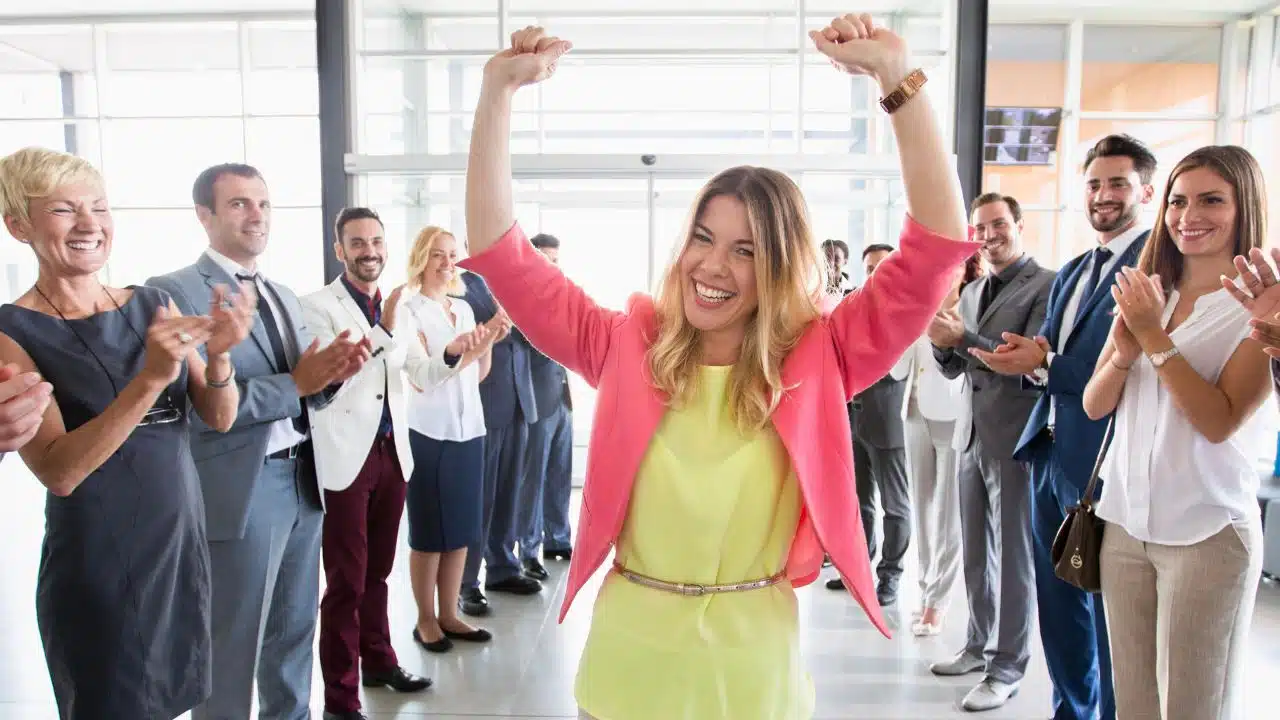 coworkers cheering for an employee