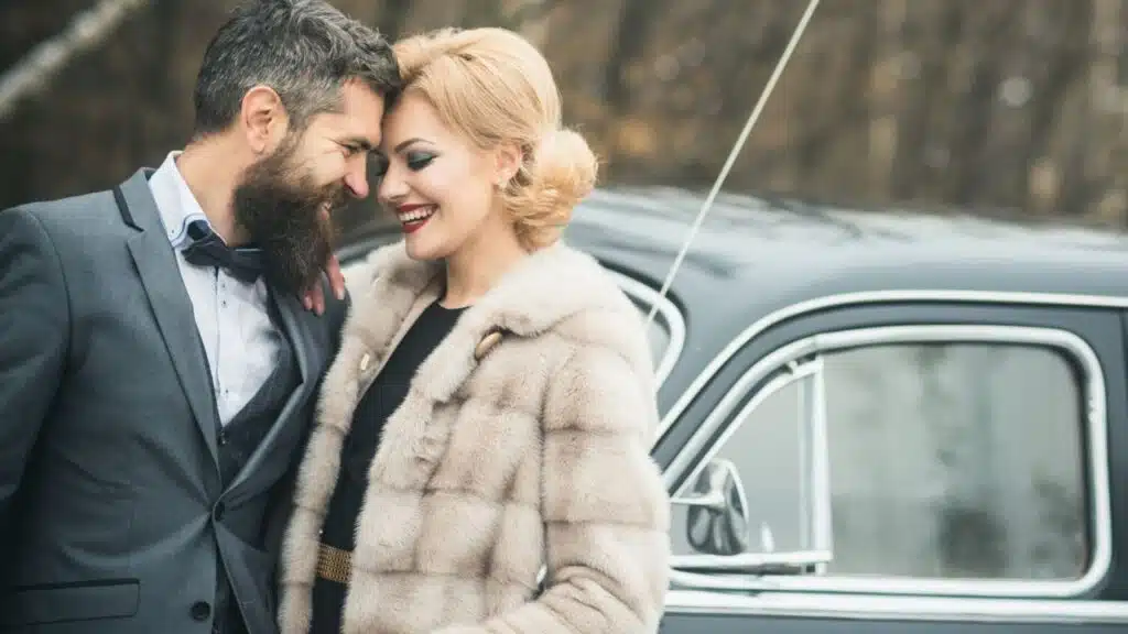 happy elegant couple outside near car