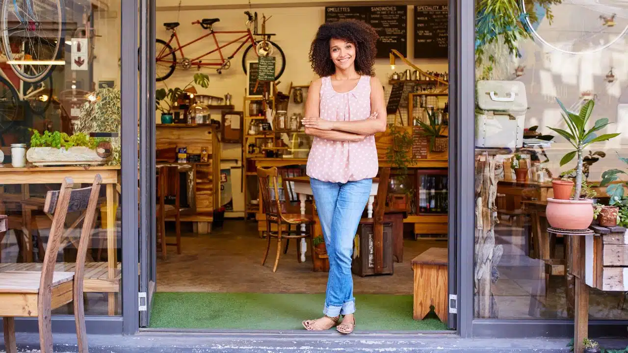 woman business owner in front of cafe