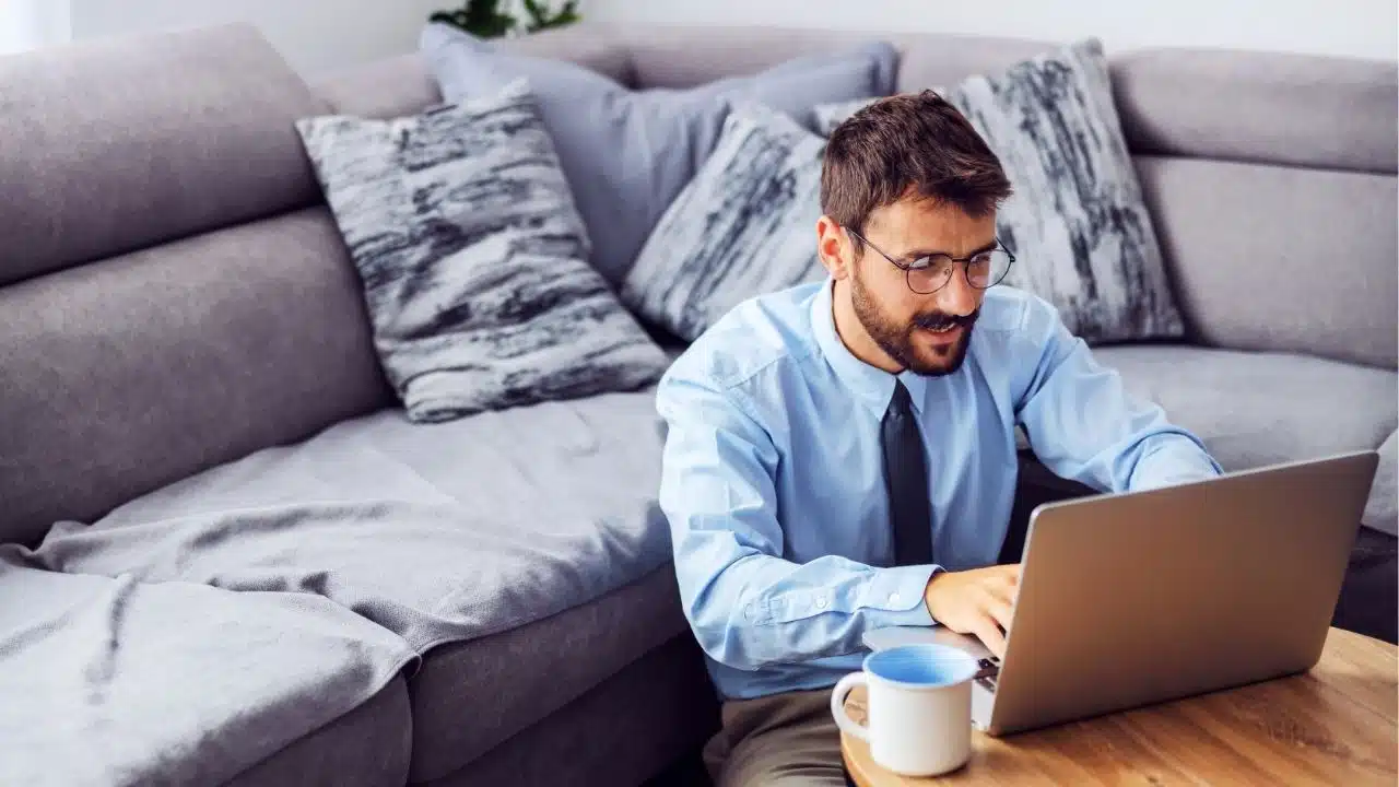 man working on laptop on coffee table