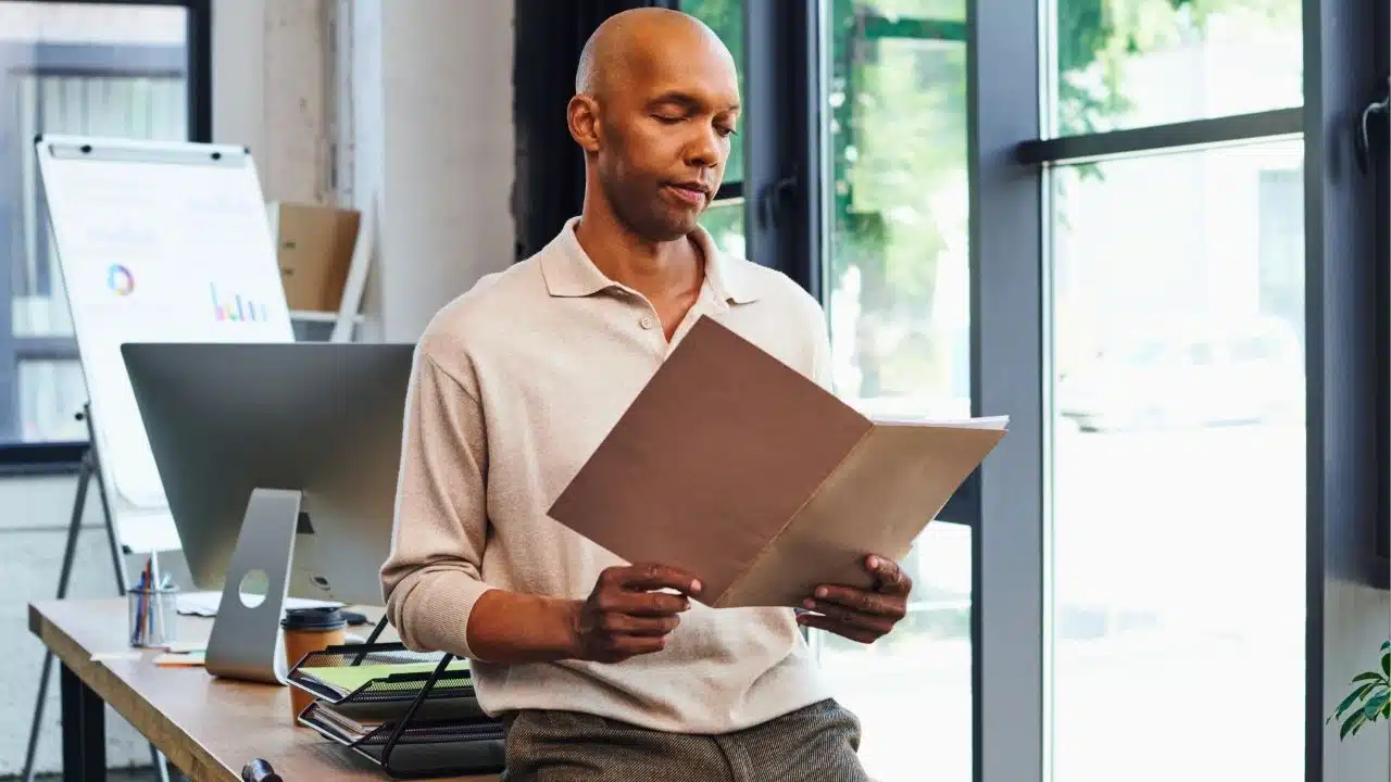 manager looking at file in office