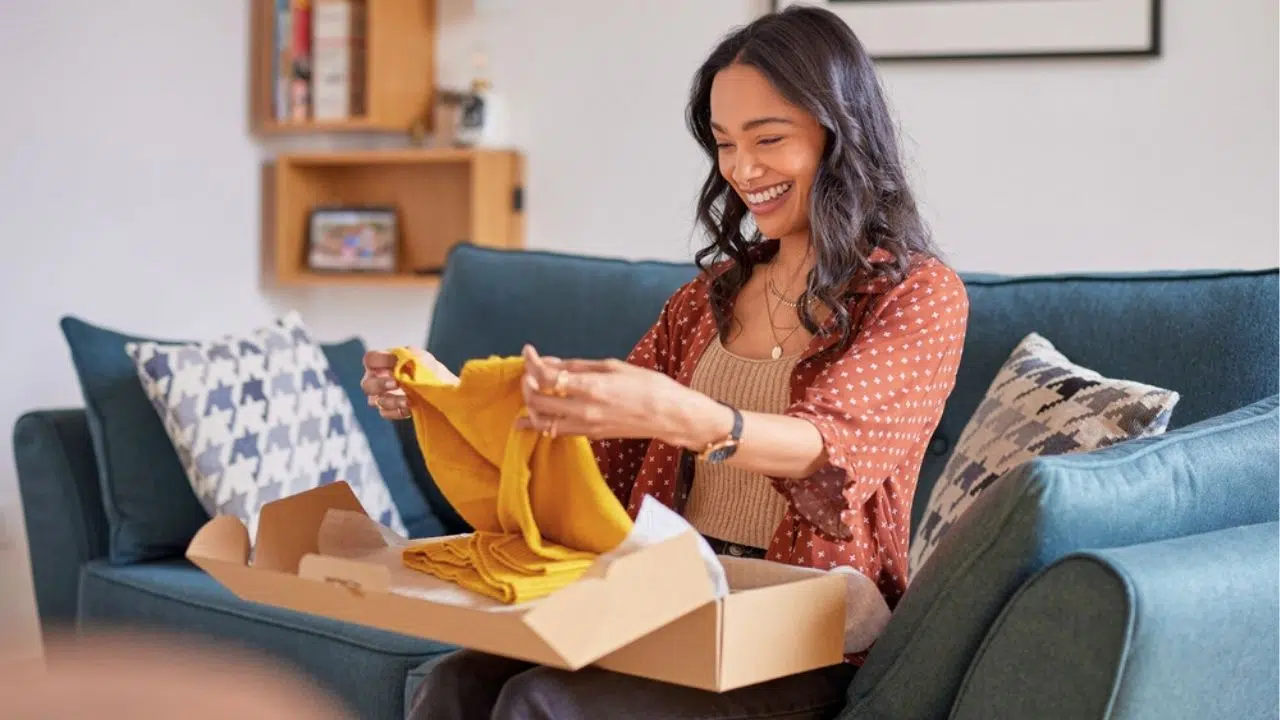 happy woman opening amazon delivery