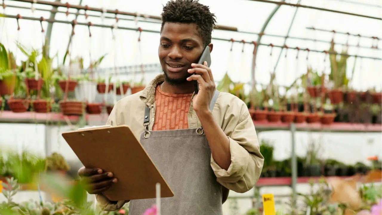 young man working in greenhouse