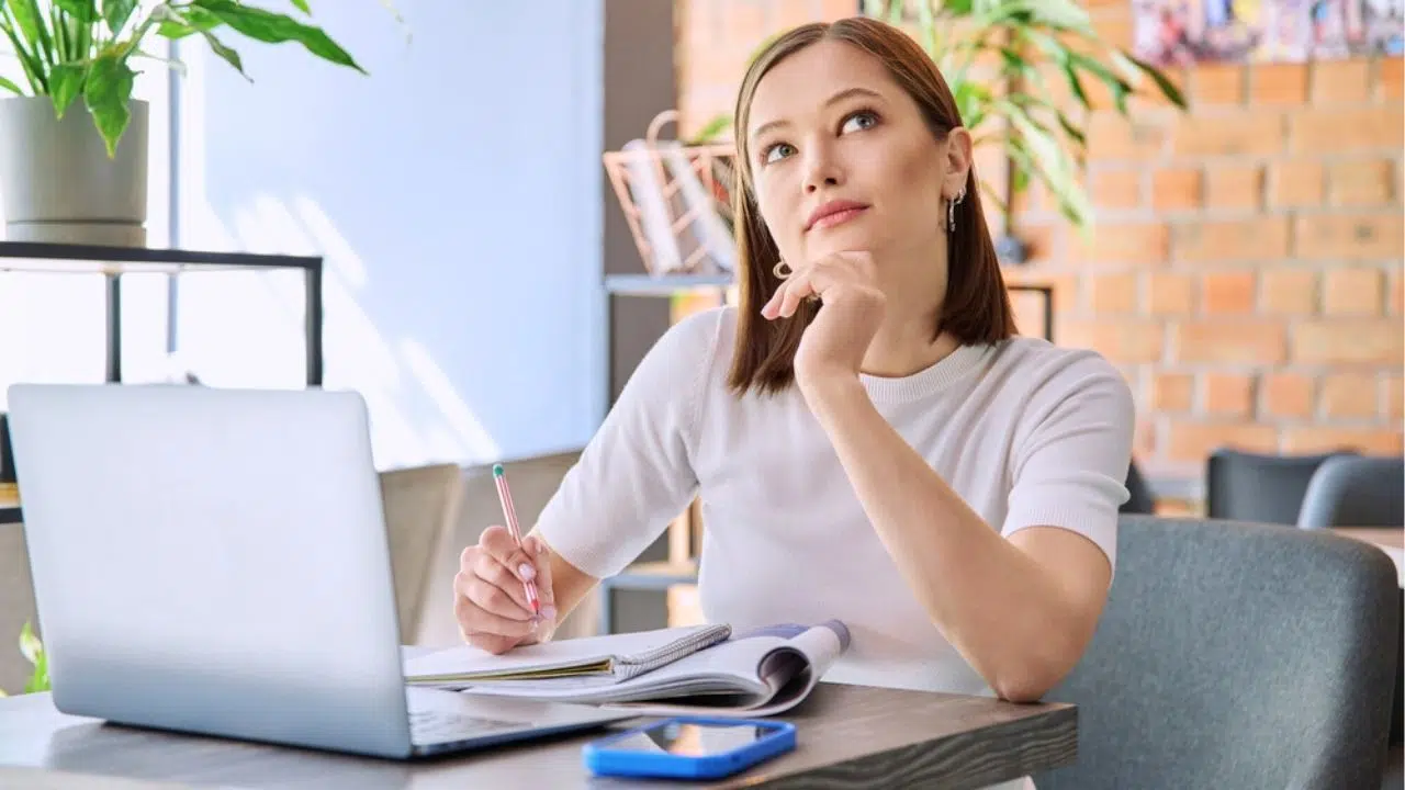 young woman studying and thinking