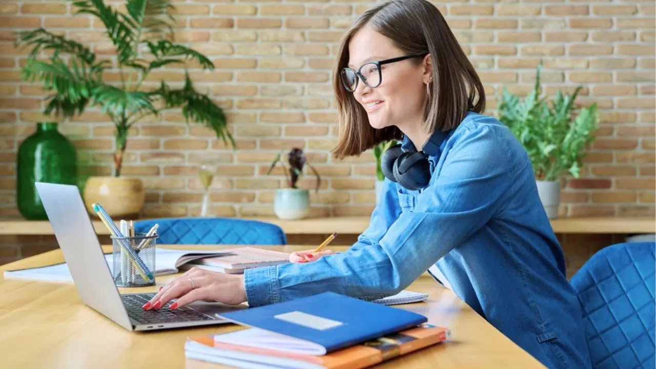 young woman studying with laptop